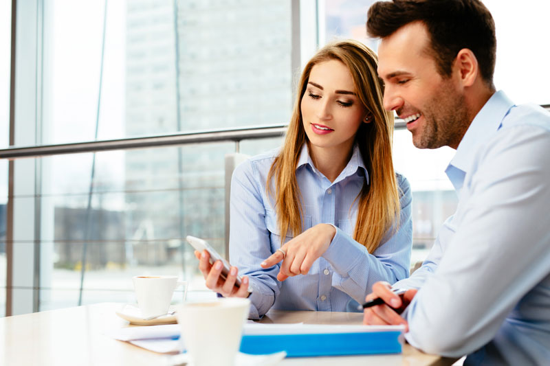 man and woman working on phone